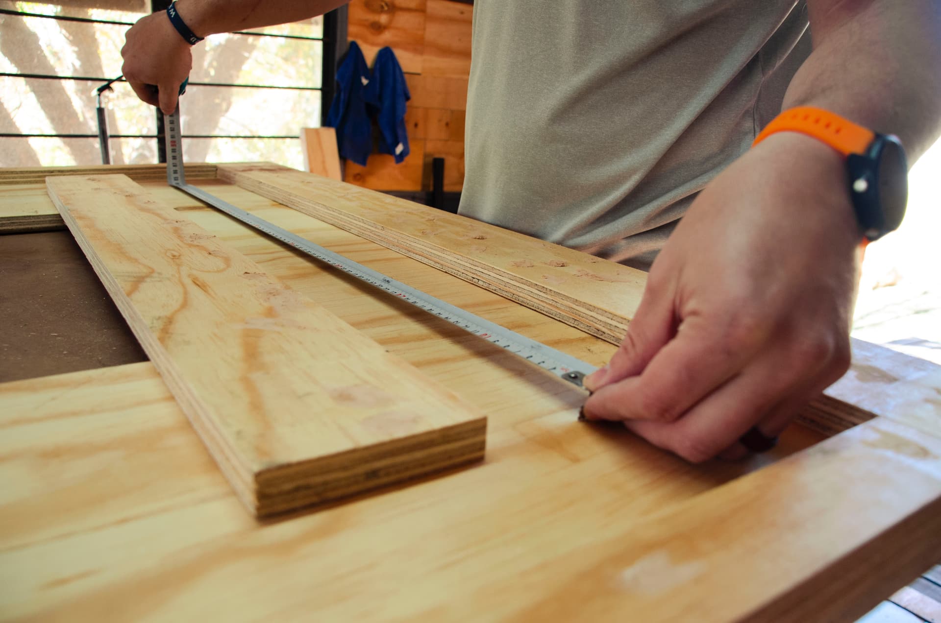 Skilled carpenter measuring timber